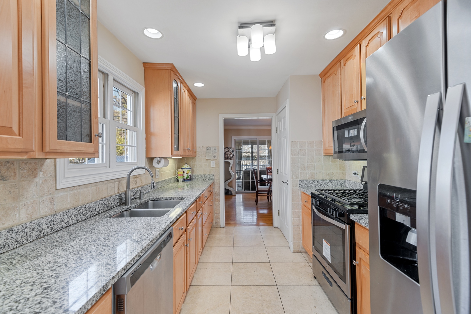 463 Green Bay Road Highland Park, IL 60035 - Photo 4 of 27 a kitchen with stainless steel appliances granite countertop a sink stove and refrigerator