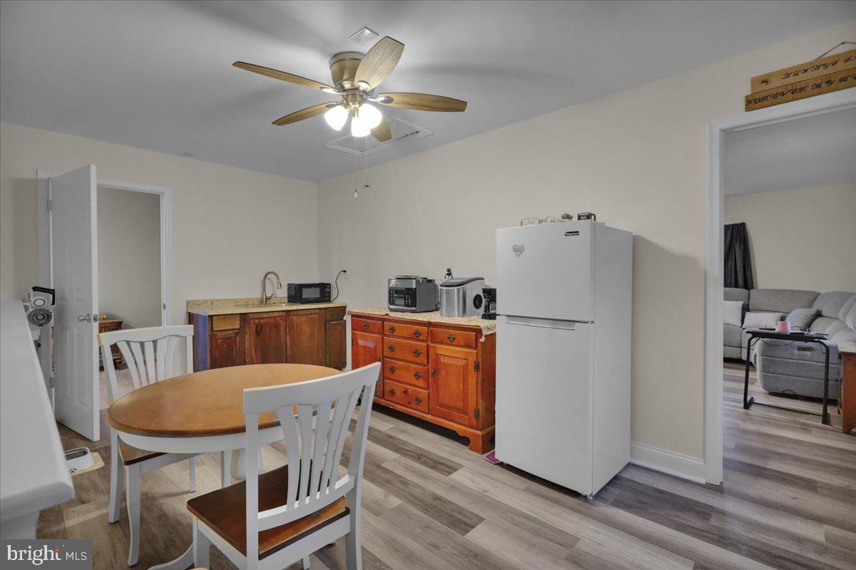 12 Trimble Boulevard Brookhaven, PA 19015 - Photo 24 of 34 a kitchen with a dining table chairs refrigerator and cabinets