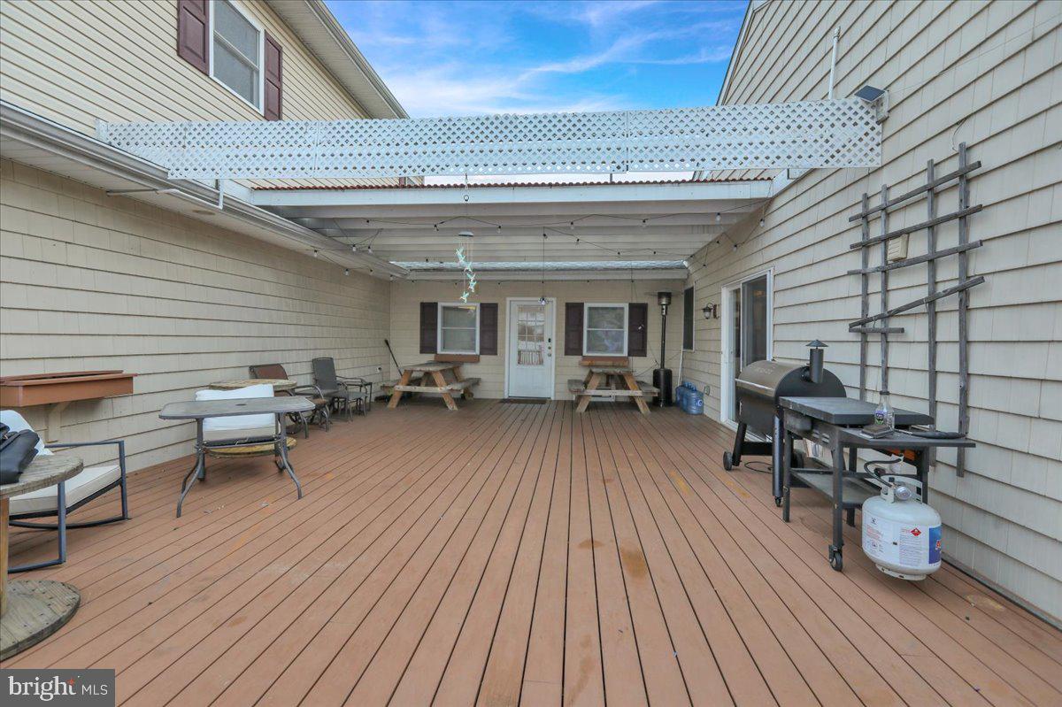 12 Trimble Boulevard Brookhaven, PA 19015 - Photo 28 of 34 a view of a patio with table and chairs barbeque with wooden floor and seating space