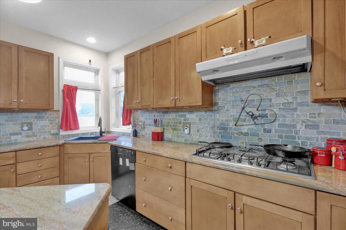 12 Trimble Boulevard Brookhaven, PA 19015 - Photo 9 of 34 a kitchen with stainless steel appliances granite countertop a sink a stove and cabinets