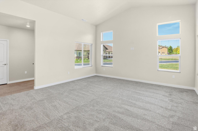 1838 West 300th Street South, Unit B Mapleton, UT 84664 - Photo 4 of 51 Spacious living area featuring vaulted ceilings, light neutral wall tones, and gray carpeting