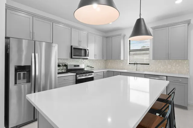 a kitchen with a sink cabinets and window