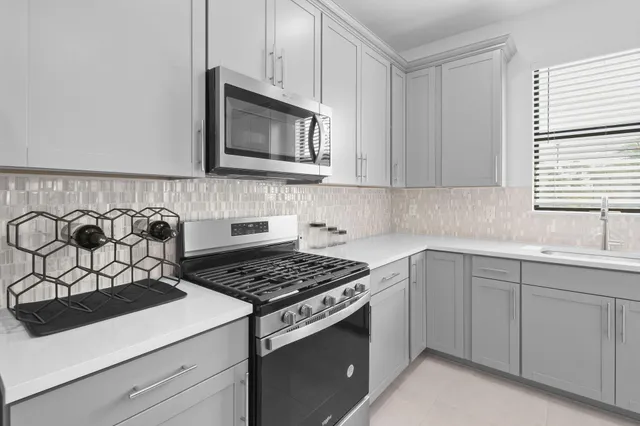 a kitchen with a sink cabinets and window