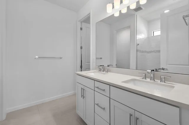 a bathroom with a sink double vanity and a mirror