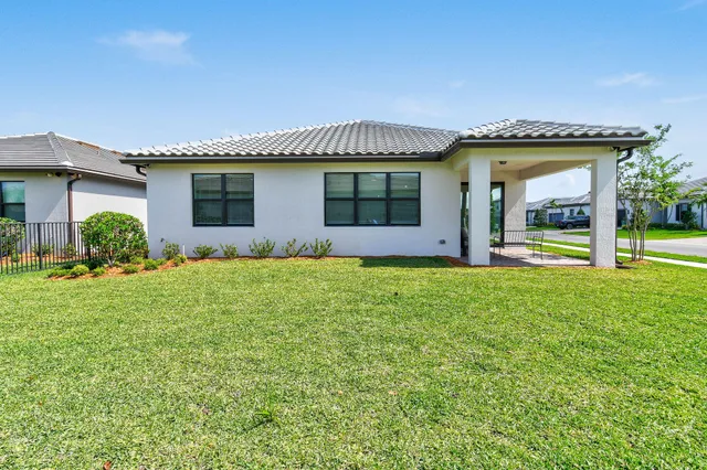 an aerial view of a house with a swimming pool patio and outdoor seating