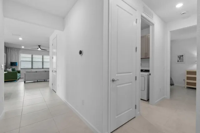 a kitchen with stainless steel appliances a dining table chairs sink and microwave