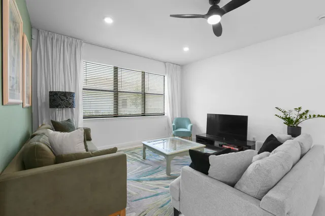 a living room with furniture and kitchen view