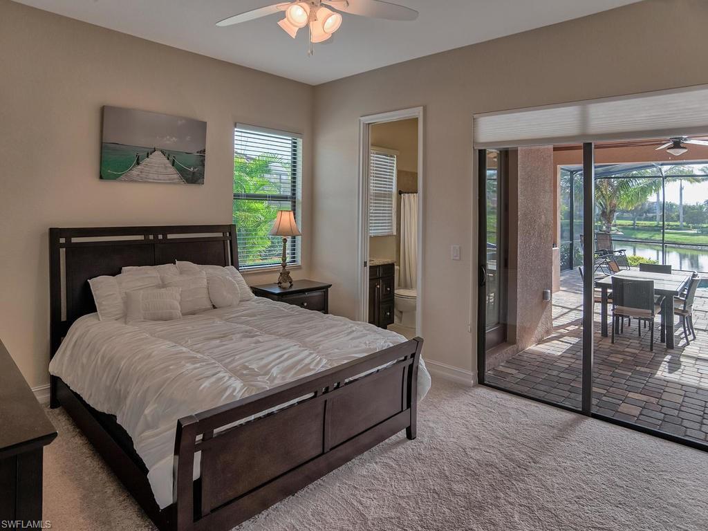 9634 Firenze Circle Naples, FL 34113 - Photo 16 of 35 a bed sitting in a spacious bedroom next to a window