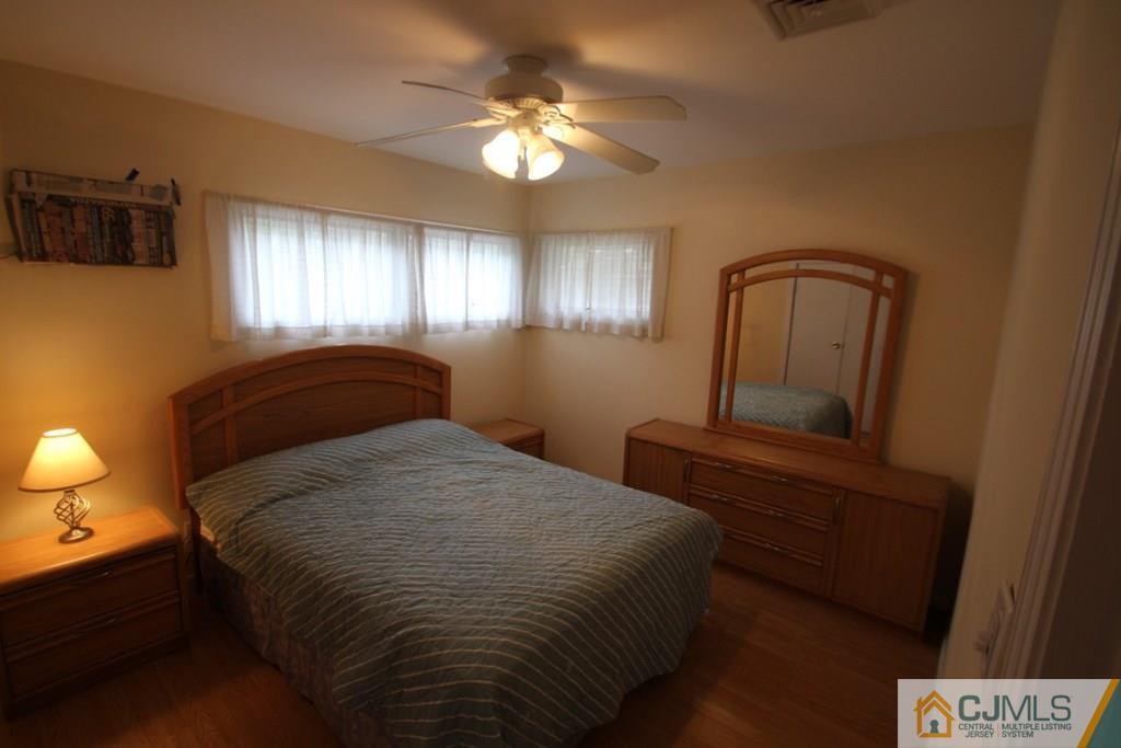 21 Sturgis Road Edison, NJ 08817 - Photo 6 of 18 a bedroom with a bed and a chandelier