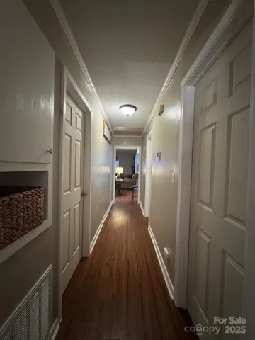 a view of hallway with wooden floor