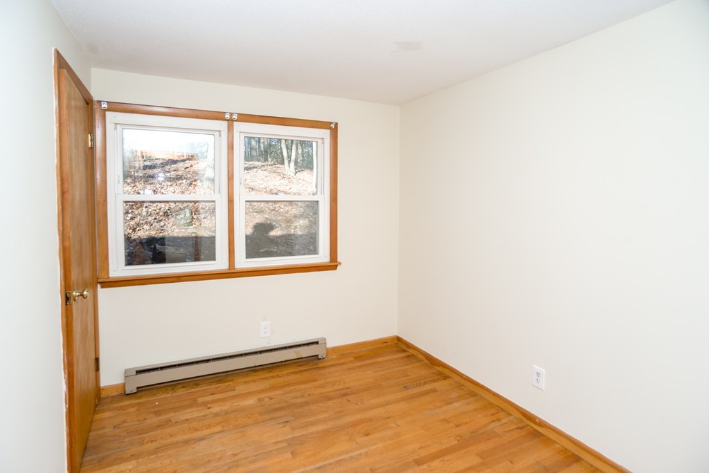 4 Harkness Road Pelham, MA 01002 - Photo 11 of 29 a view of an empty room with wooden floor and a window