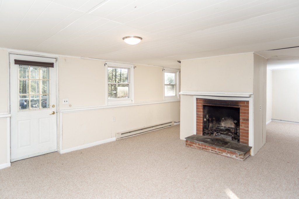 4 Harkness Road Pelham, MA 01002 - Photo 18 of 29 an empty room with windows and fireplace