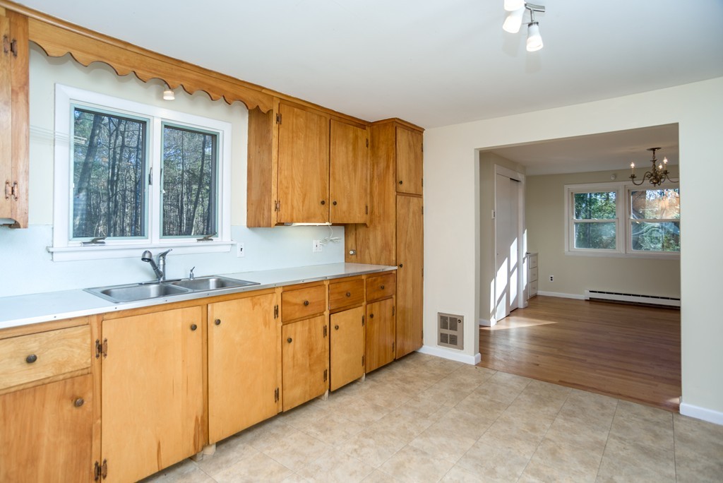 4 Harkness Road Pelham, MA 01002 - Photo 4 of 29 a view of a kitchen with a sink dishwasher a fireplace and cabinets