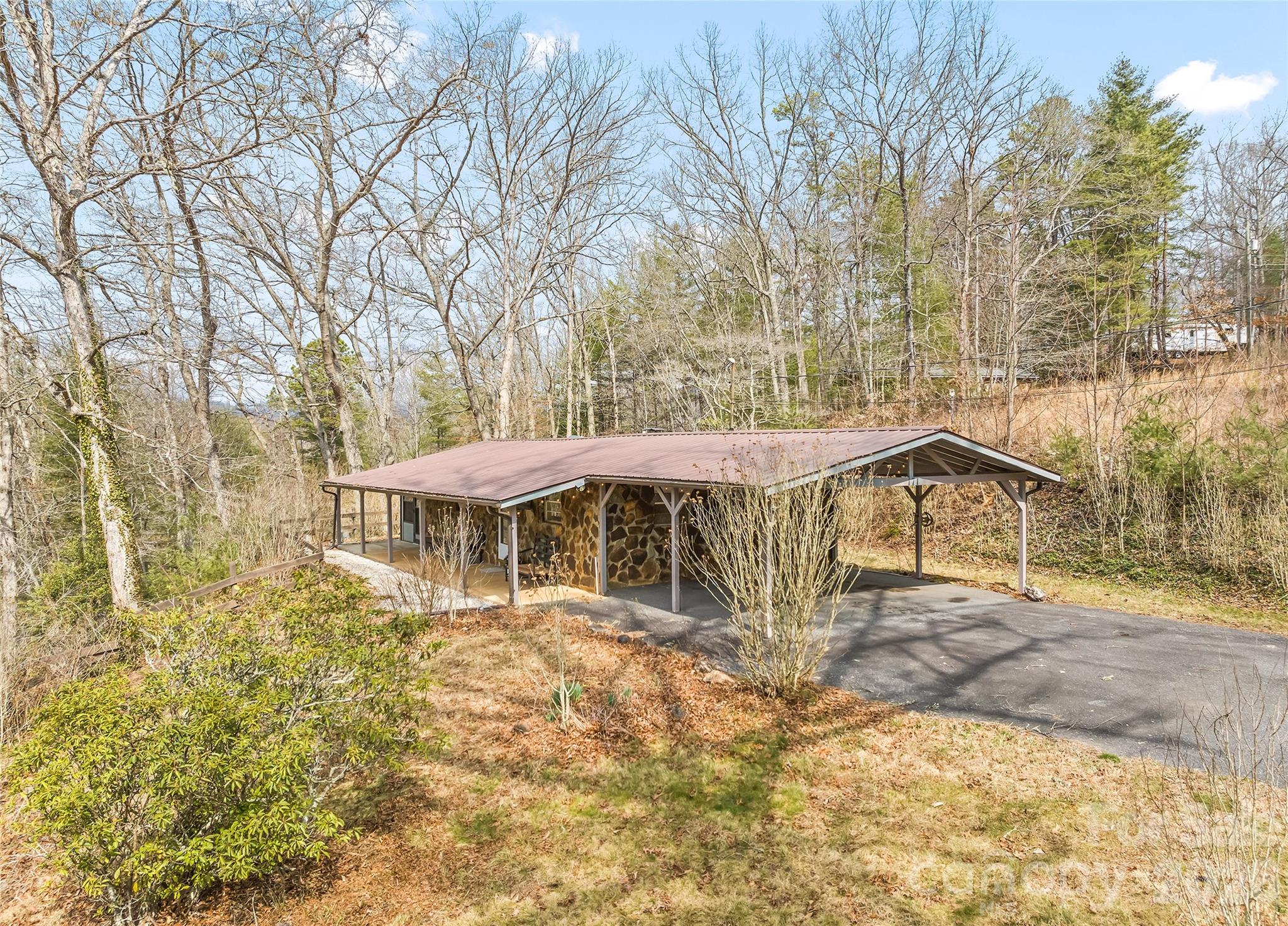 171 Fortner Road Bryson City, NC 28713 - Photo 2 of 32 a view of a house with large trees and wooden fence