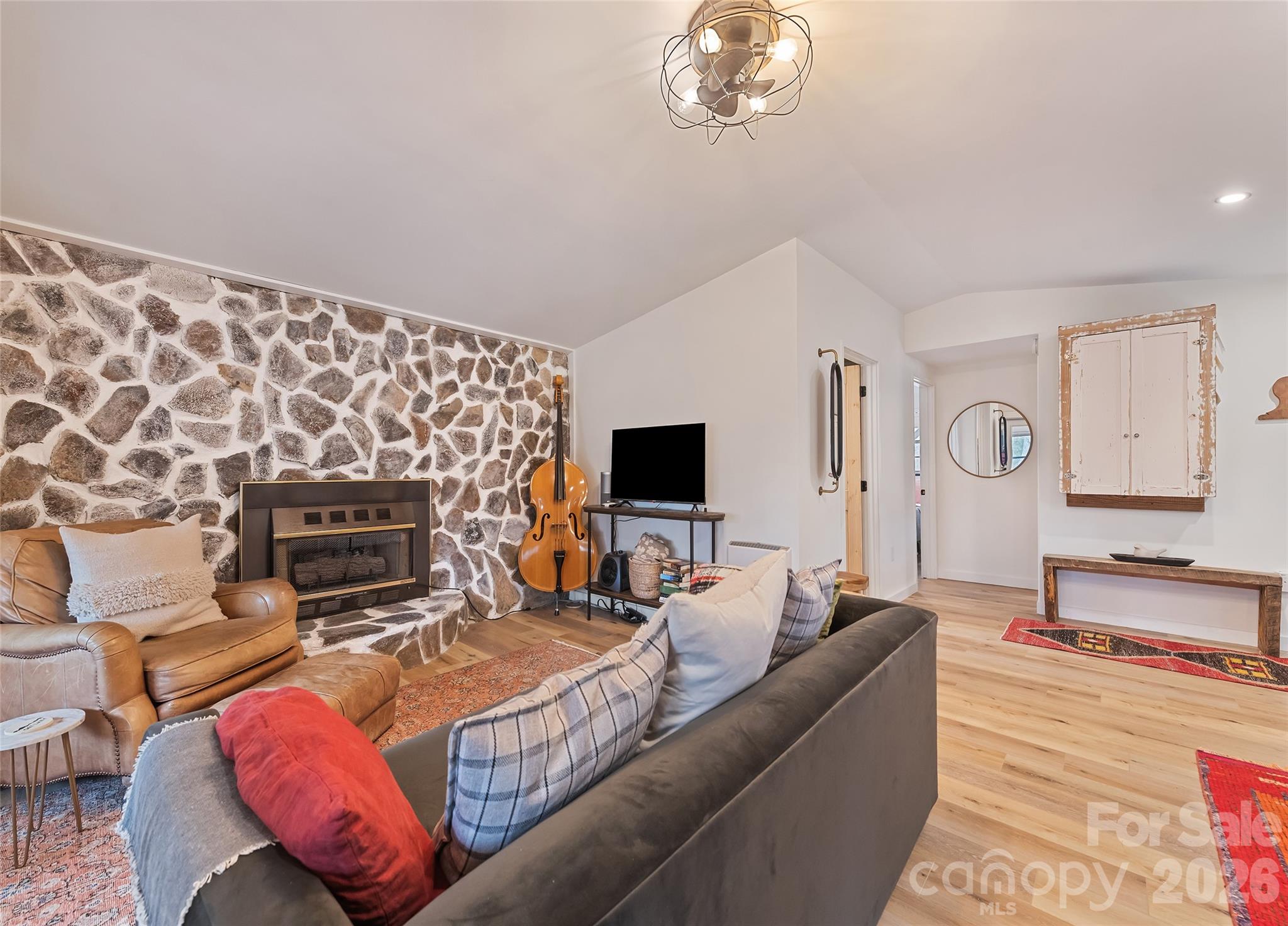171 Fortner Road Bryson City, NC 28713 - Photo 5 of 32 a living room with furniture a flat screen tv and a fireplace