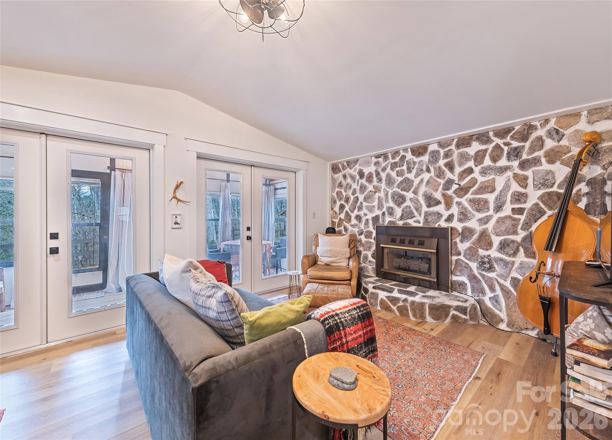 171 Fortner Road Bryson City, NC 28713 - Photo 6 of 32 a living room with furniture a fireplace and a table
