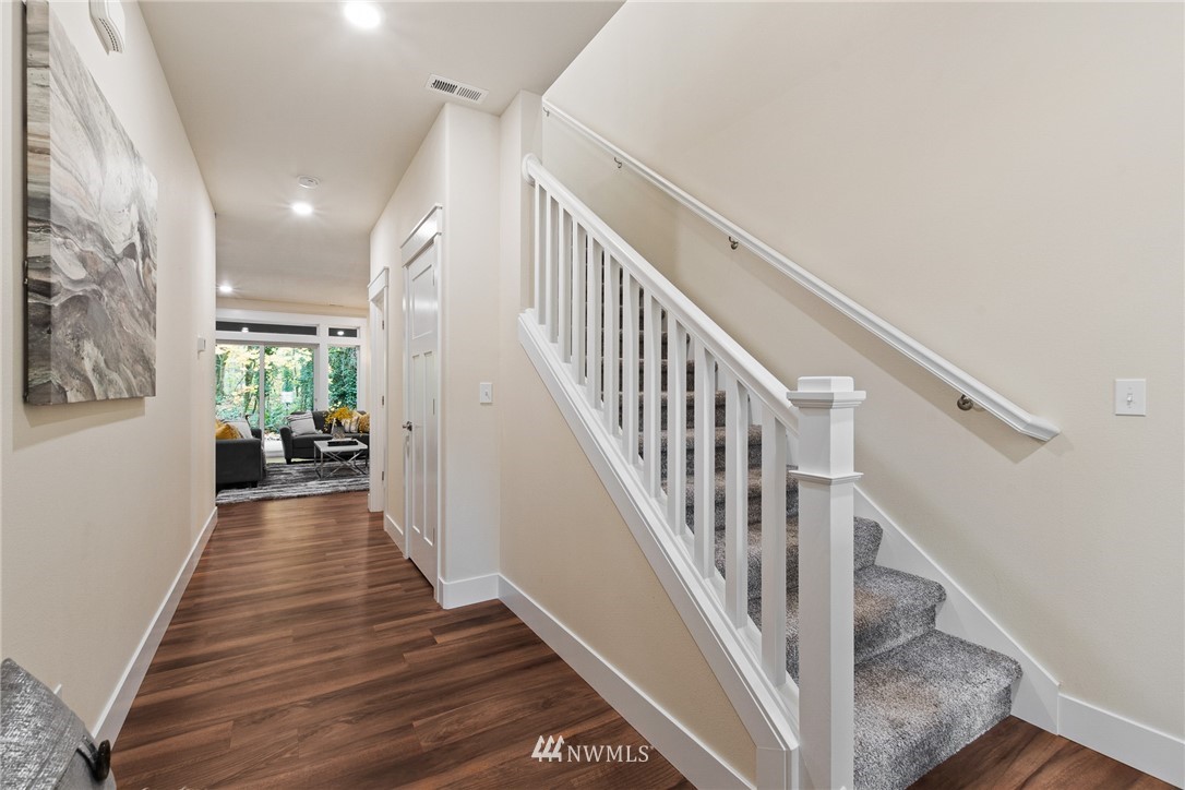 17839 Southeast 128th Street Renton, WA 98059 - Photo 11 of 35 a view of a hallway with wooden floor and staircase