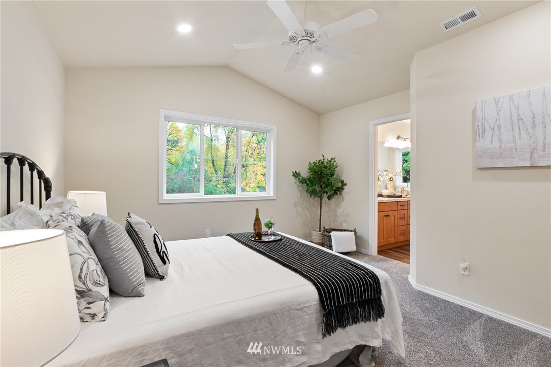 17839 Southeast 128th Street Renton, WA 98059 - Photo 12 of 35 a bedroom with a large bed and potted plant