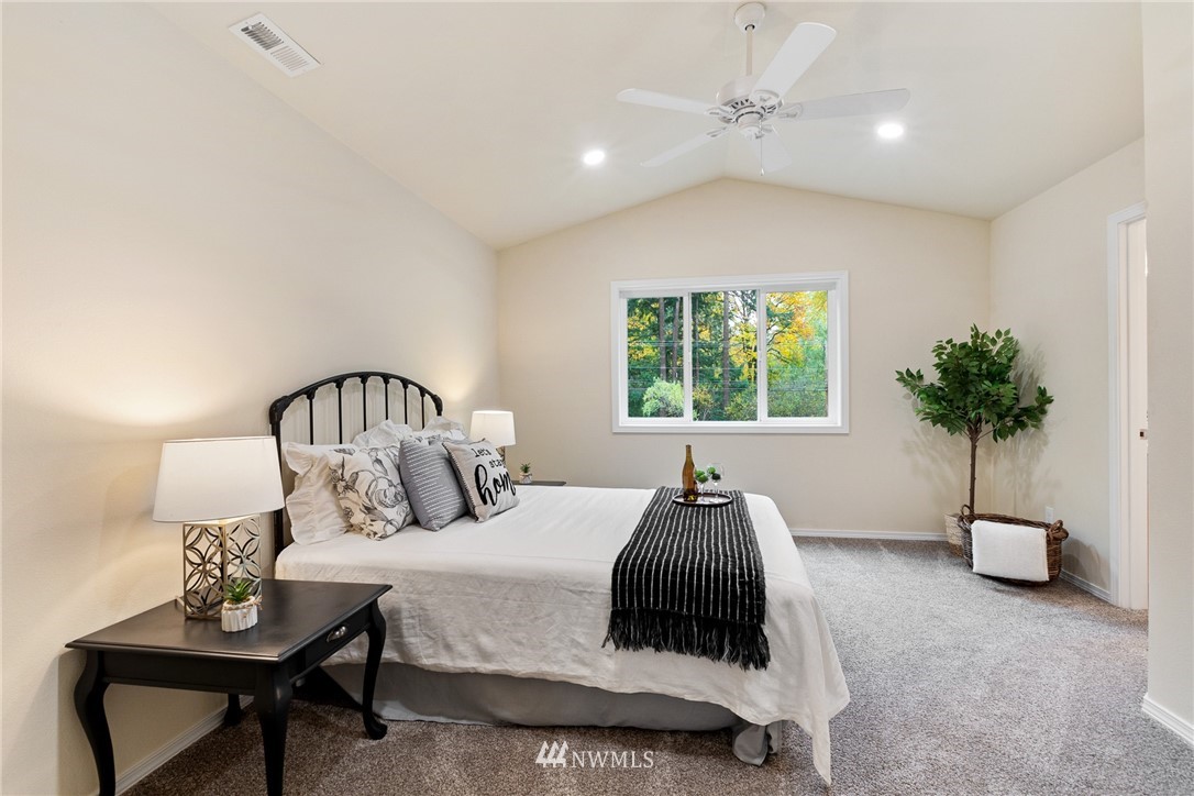 17839 Southeast 128th Street Renton, WA 98059 - Photo 13 of 35 a bedroom with a bed and a potted plant