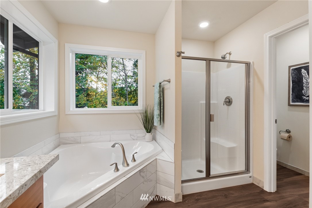 17839 Southeast 128th Street Renton, WA 98059 - Photo 15 of 35 a bathroom with a tub a shower and view