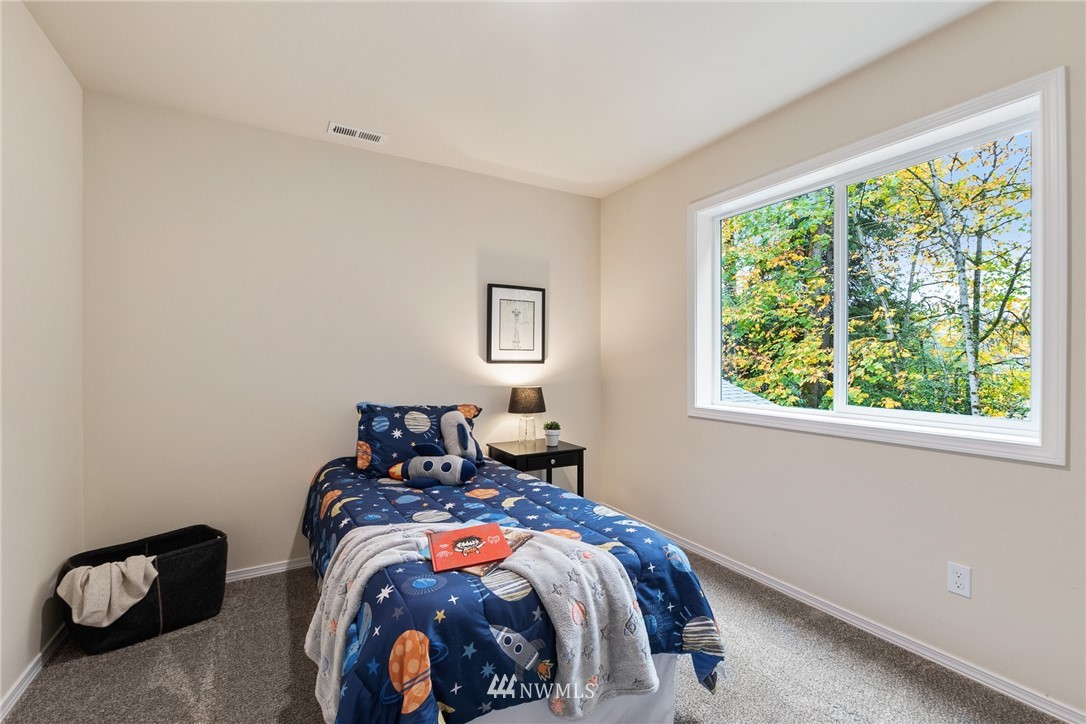 17839 Southeast 128th Street Renton, WA 98059 - Photo 18 of 35 a bedroom with a bed and a window
