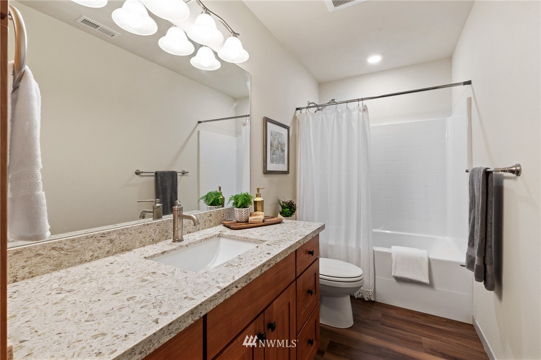 17839 Southeast 128th Street Renton, WA 98059 - Photo 20 of 35 a bathroom with a granite countertop sink toilet and shower