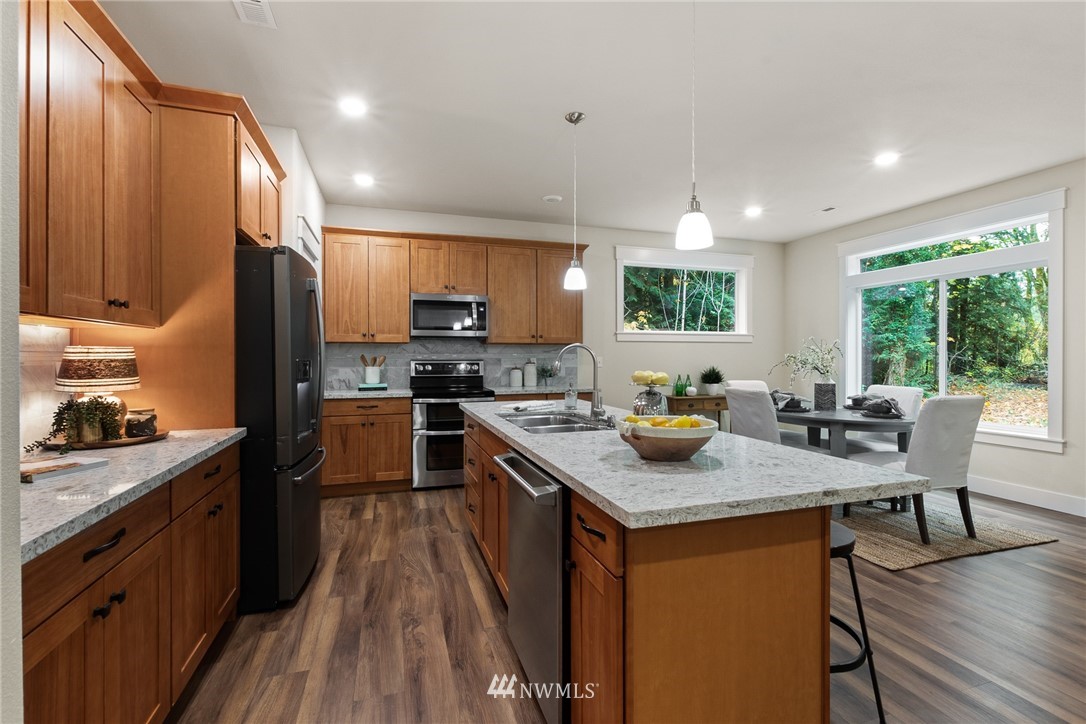 17839 Southeast 128th Street Renton, WA 98059 - Photo 8 of 35 a kitchen with stainless steel appliances granite countertop sink stove top oven and cabinets