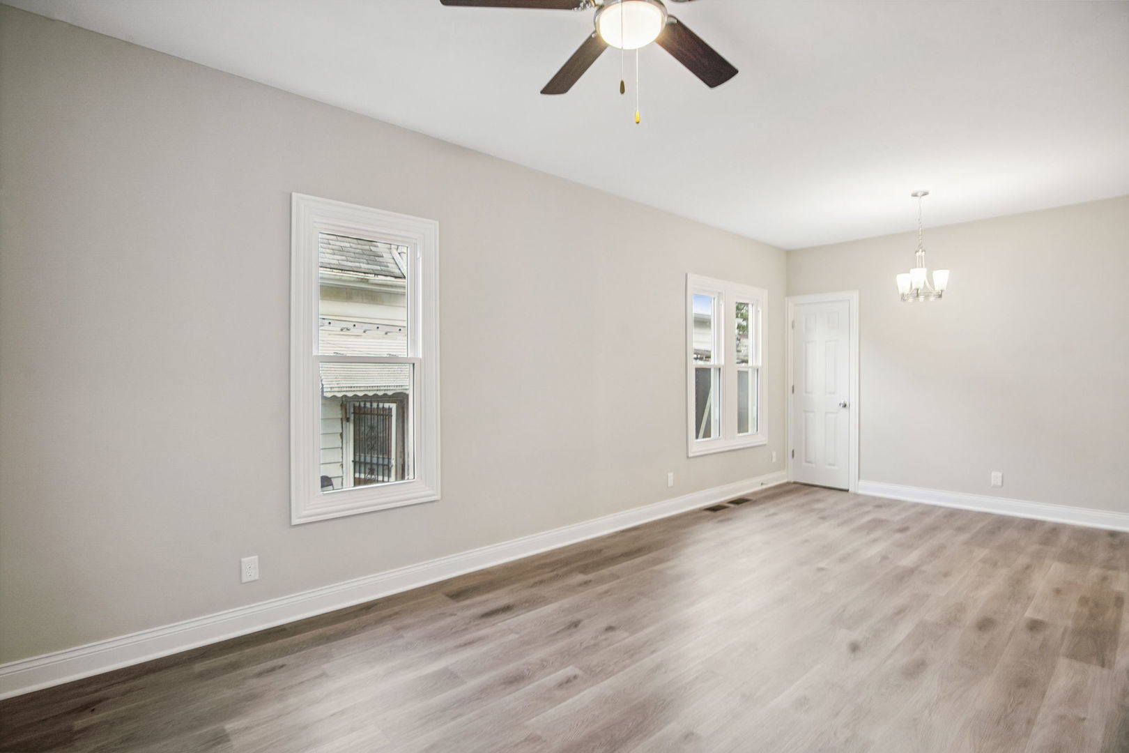 1424 Clark Street DeKalb, IL 60115 - Photo 12 of 23 a view of an empty room with a window and wooden floor