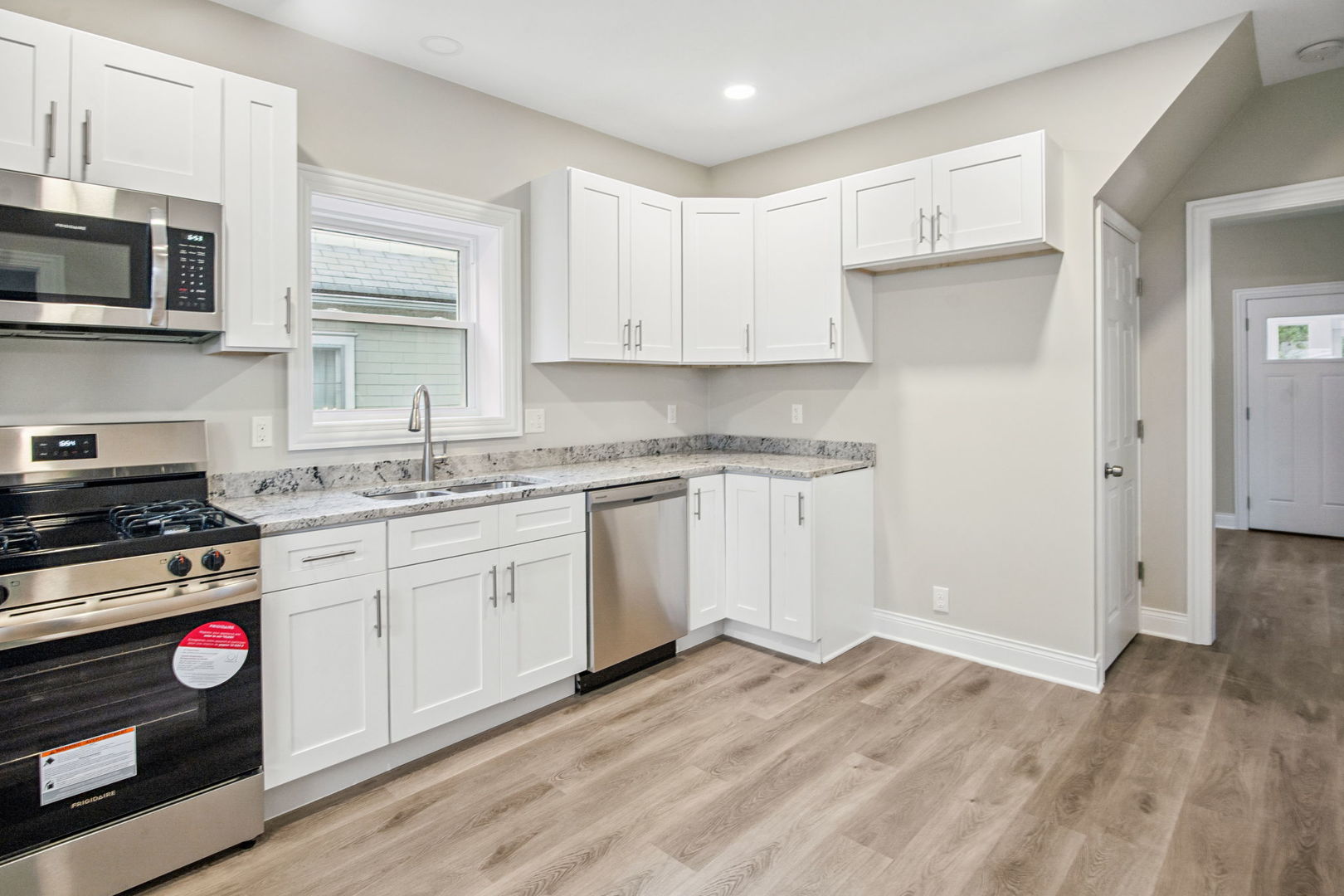 1424 Clark Street DeKalb, IL 60115 - Photo 15 of 23 a kitchen with stainless steel appliances granite countertop a stove and white cabinets