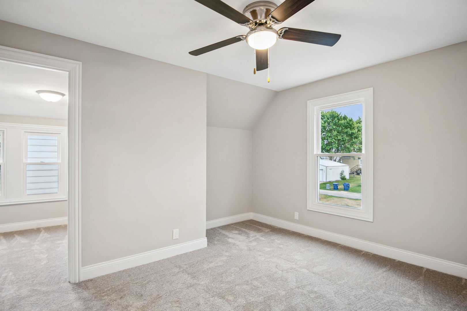 1424 Clark Street DeKalb, IL 60115 - Photo 18 of 23 an empty room with windows and fan