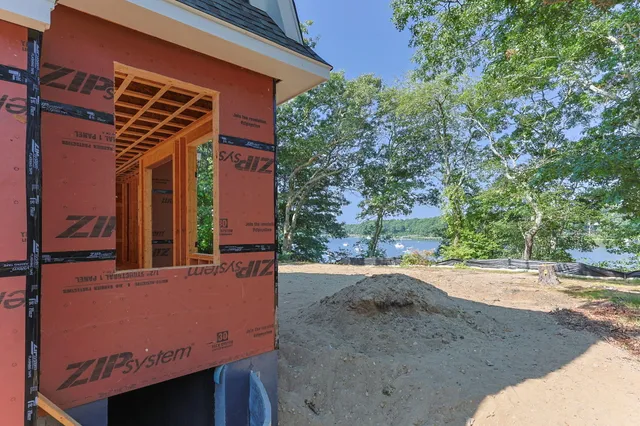 an aerial view of residential house with outdoor space and lake view