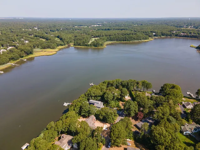an aerial view of a houses with a lake view