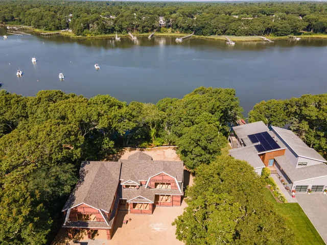 an aerial view of a house with a lake view