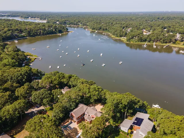 an aerial view of lake and residential houses with outdoor space
