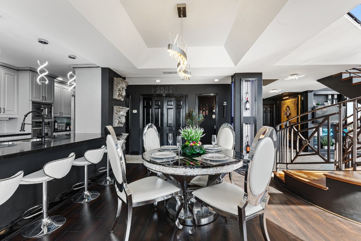 3350 McCue Road, Unit 2404 Houston, TX 77056 - Photo 12 of 49 a view of a dining room with furniture and wooden floor