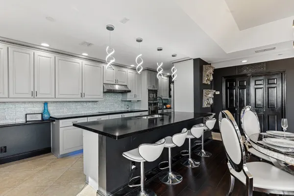 a kitchen with stainless steel appliances granite countertop a sink and cabinets