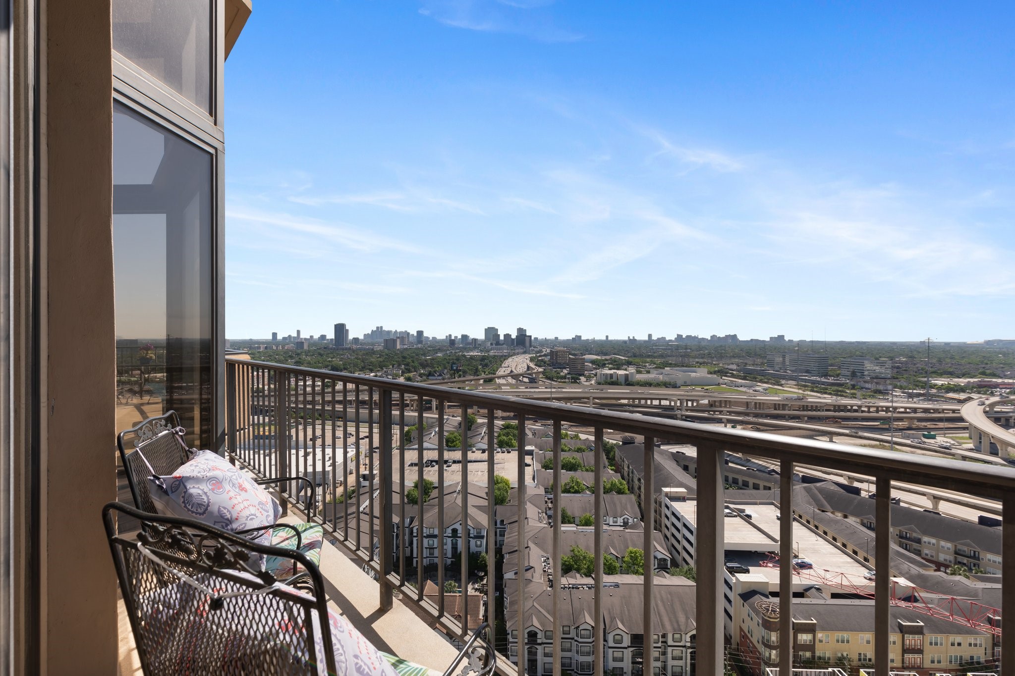 3350 McCue Road, Unit 2404 Houston, TX 77056 - Photo 19 of 49 a view of a balcony with wooden floor next to a city view