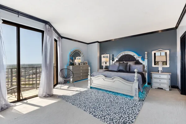 a bedroom with a large bed and a window