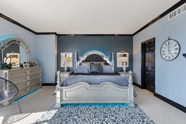 a bedroom with a bed and a dresser