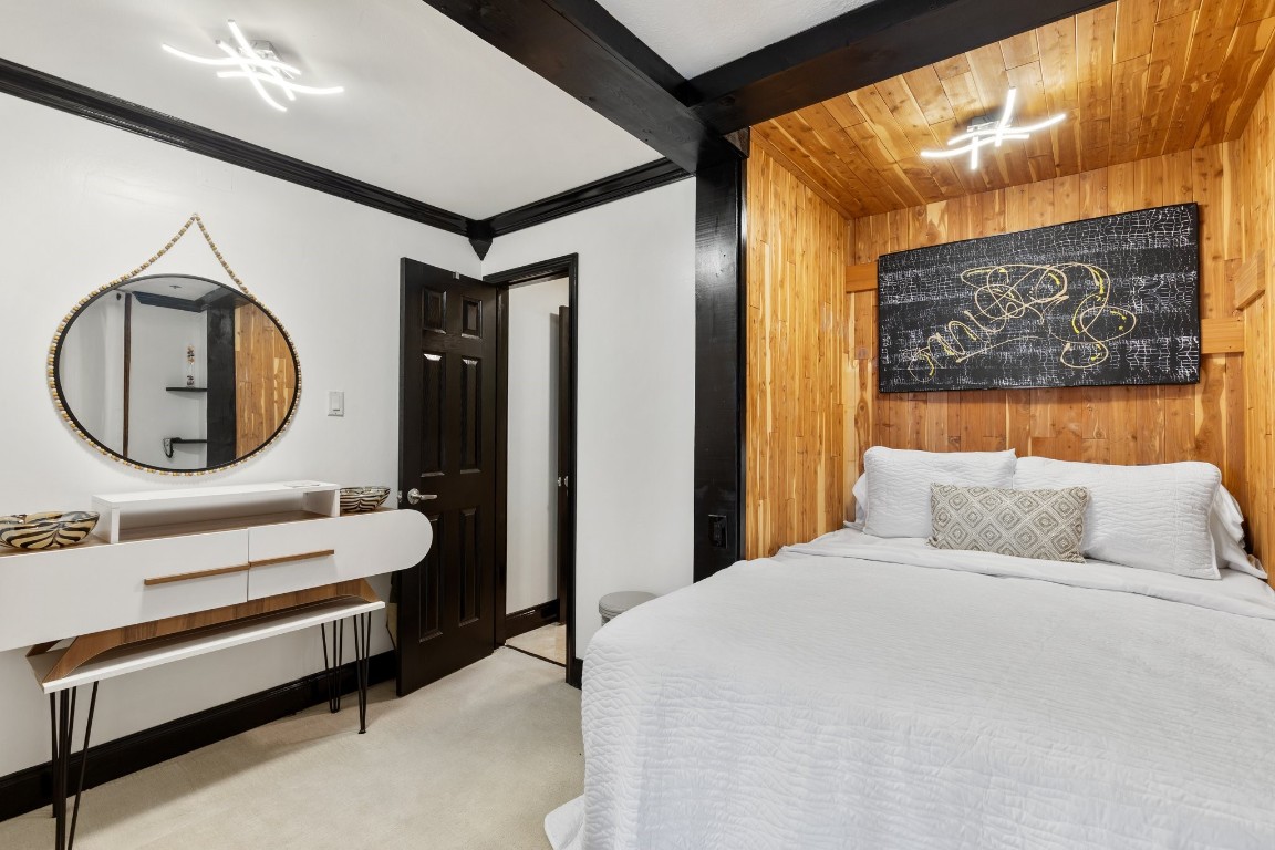 3350 McCue Road, Unit 2404 Houston, TX 77056 - Photo 40 of 49 a bedroom with a bed a mirror and paintings on the wall