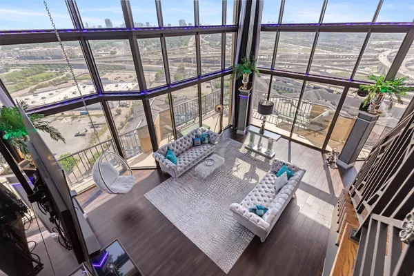 a living room with furniture and a floor to ceiling window