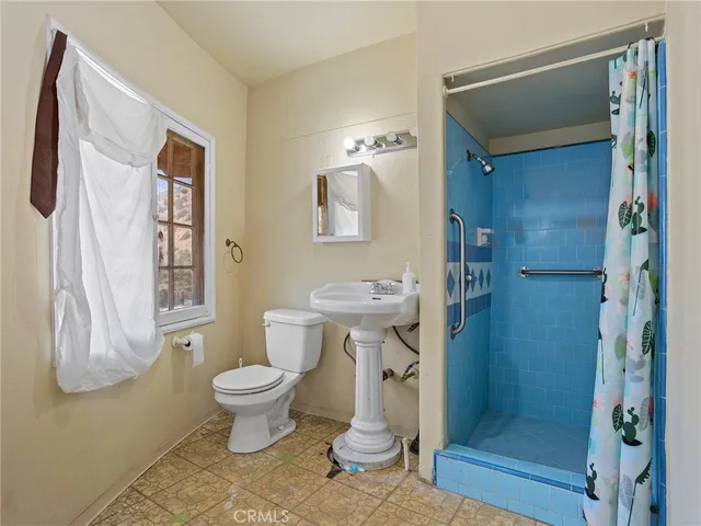 a bathroom with a toilet sink and shower