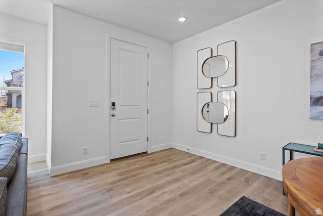 488 West Greenstone Pl Street, Unit 1010 St. George, UT 84790 - Photo 13 of 34 Bright entry area featuring a two-panel white door with dark hardware, recessed ceiling lighting, and light wood-finish flooring