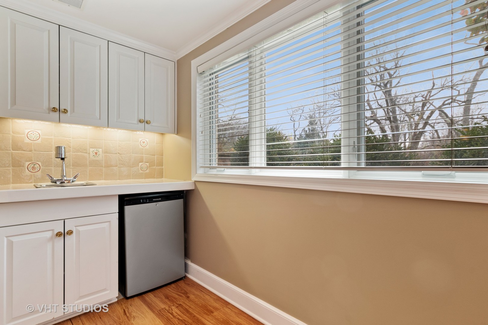 375 Maple Row Northfield, IL 60093 - Photo 15 of 38 a kitchen with white cabinets and a window