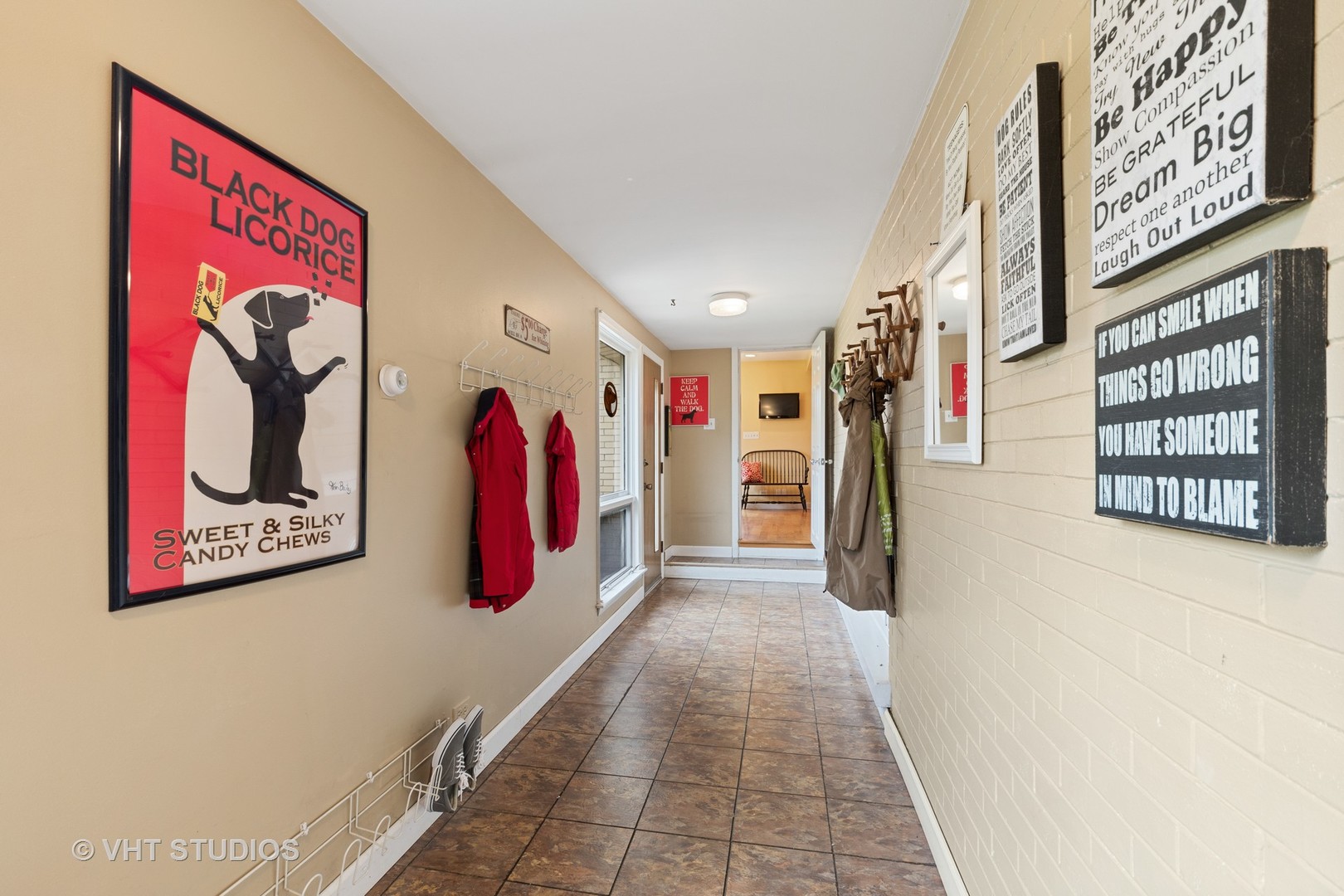 375 Maple Row Northfield, IL 60093 - Photo 17 of 38 a hallway with painting on the wall and a shower