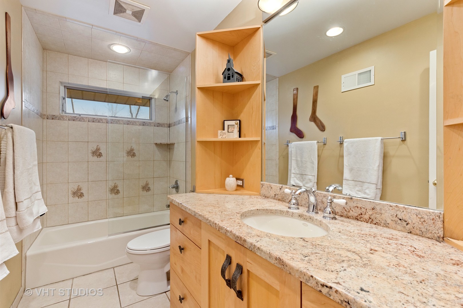 375 Maple Row Northfield, IL 60093 - Photo 24 of 38 a bathroom with a granite countertop sink vanity mirror bathtub shower and a toilet