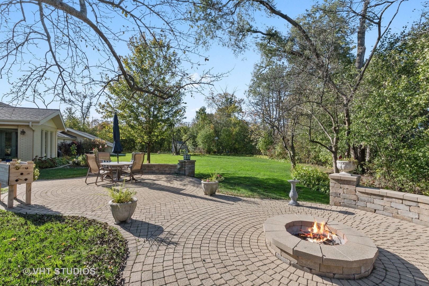 375 Maple Row Northfield, IL 60093 - Photo 29 of 38 a view of a backyard with table and chairs potted plants and large tree