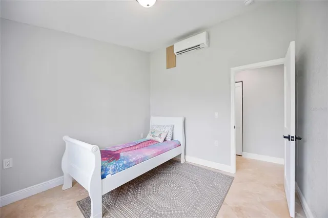 a bedroom with a bed and a wall painting