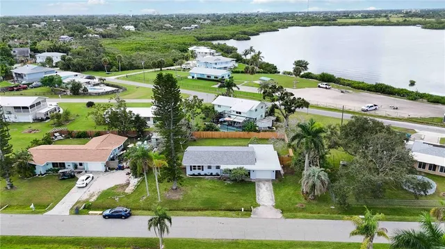 an aerial view of a house with a garden and lake view