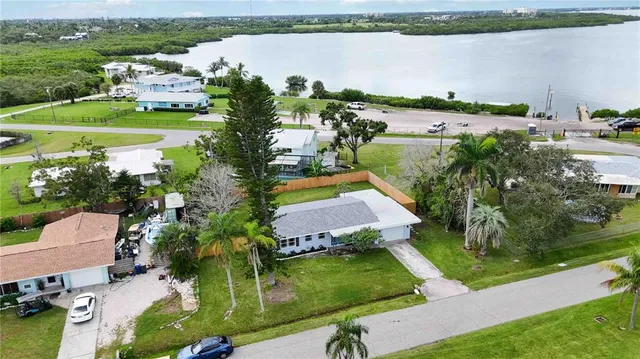 an aerial view of a houses with a lake view